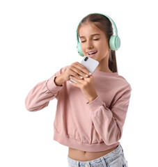 Teenage girl in headphones with mobile phone singing on white background. Dream concept