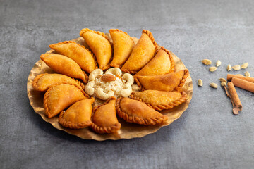 Gujia is a crispy, crescent-shaped Indian sweet filled with khoya, coconut, and dry fruits, traditionally enjoyed during Holi festival.
