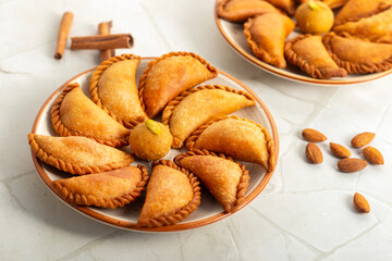 Gujia is a crispy, crescent-shaped Indian sweet filled with khoya, coconut, and dry fruits, traditionally enjoyed during Holi festival.
