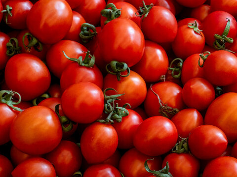 Vibrant red cherry tomatoes full frame background