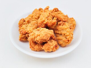 Breaded fried chicken in a white plate on a white background.