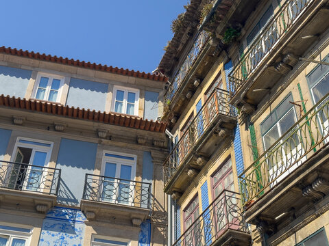 Old European building facade with stone walls, ornate balconies and classic windows. Elegant