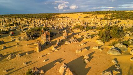Stunning bird's-eye view of Pinnacles Desert under a vibrant sunset sky in Western Australia