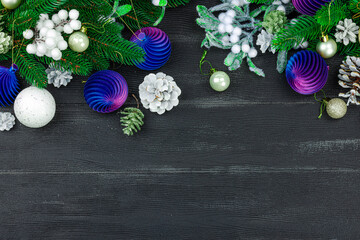 Happy New Year background. Festive Christmas baubles, evergreen branches, pine cones, snowy berries