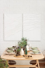 Winter table setting with pine cones and branches in room