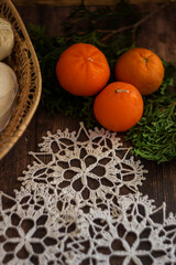 Flat lay with handmade crochet snowflakes on rustic wooden background. Minimal cozy winter composition for craft projects, holiday cards, and eco-friendly Christmas decor.