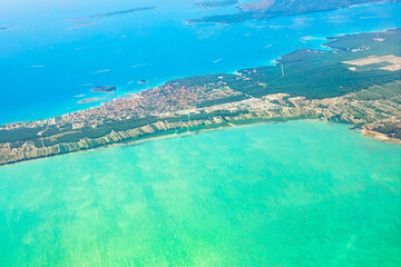 Aerial view capturing contrast between the deep blue sea and shallow turquoise water near the coast in Dalmatia Croatia
