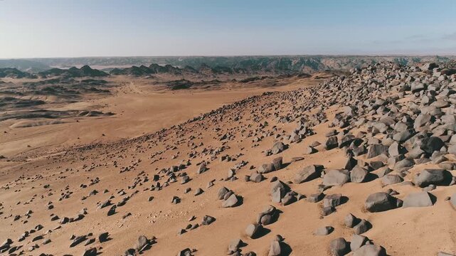 flight along namib desert dune covered with rocks