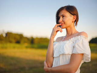 Woman in white dress walking through sunset field in Croatia