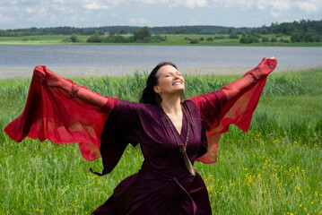 Portrait of a middle-aged shaman woman with a red headscarf