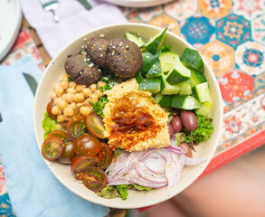 Falafel hummus bowl with fresh vegetables olives and chickpeas