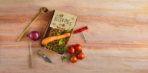 vintage recipe or cook book with various vegetables and vintage kitchen utensils, cooking, menu food and drink concept.Free copy space
