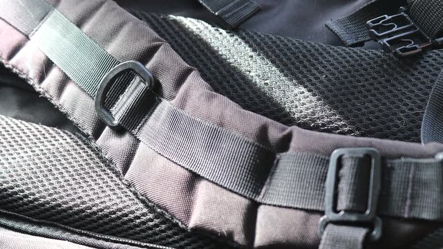 A close-up view of a backpack with a buckle