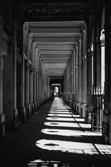 Monochrome architectural perspective of classical colonnade with light and shadow 