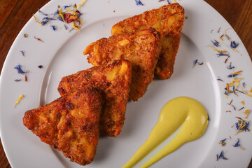 Rosti di pătate con speck e provola fritti e serviti come antipasto in un pub