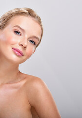 Beautiful face of young adult woman with clean fresh skin.