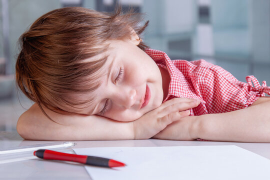 Funny concept of a child sleeping at an office desk, dreaming magical dreams while pretending to be at work. Business humor and imagination in childhood. - Powered by Adobe