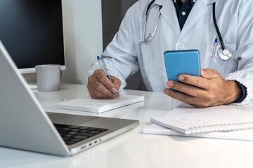 Doctor engaging with a smartphone in a modern medical setting, seamlessly integrating digital tools into patient care