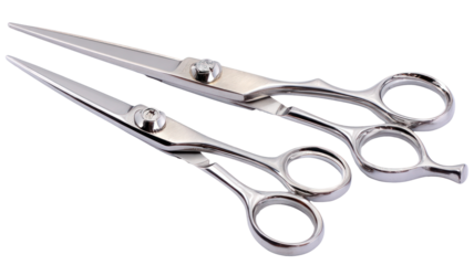 Two silver metal barber scissors isolated on transparent background