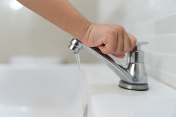 Save water. Little kid keeps turning off the running water in the bathroom to protect environment....