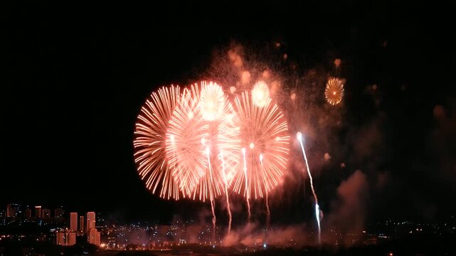 Close up of firework rocket with bright sparks ready to launch into night sky, blurry colorful fireworks in the background, festive mood firework spark, new year