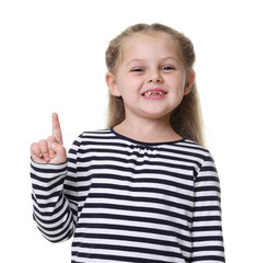 Smiling little girl pointing upwards on white background