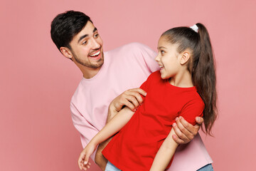 Young smiling happy parent man with child girl she wear red casual clothes. Daddy little kid...