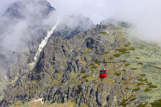 Red cable car cabin to Lomnicky stit against the backdrop of High Tatras, Slovakia