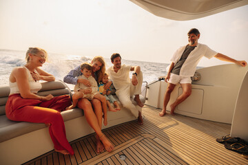 Cheerful family relishing a motorboat excursion at sunset on the open water
