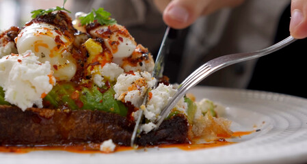 sandwich with cheese, egg, and fish in a café