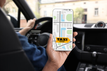 Man sitting in taxi that he called via mobile phone app, closeup