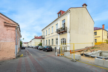 Old European Street with Yellow Building and Cars