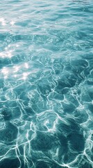 Sparkling turquoise water surface with shimmering light reflections creating abstract patterns