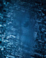 Textured blue surface with abstract patterns and subtle light effects