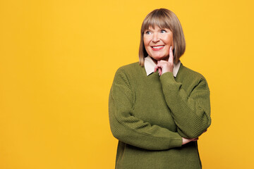 Elderly blonde woman she wear green sweater casual clothes put hand prop up on chin, lost in...