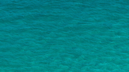 The light blue and turquoise surface of the sea. Ideal for textures, patterns and backgrounds.