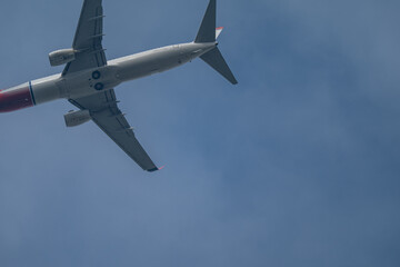 Jet Airliner Soaring Overhead Against a Blue Sky with Copy Space