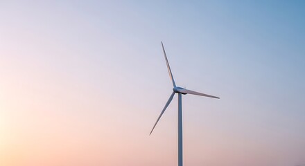 Obraz premium Wind turbine spinning during sunset symbolizing clean and renewable energy.