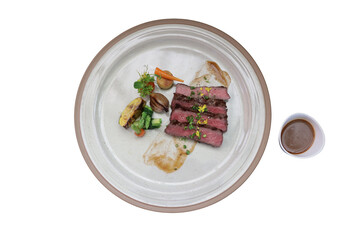 A delicious steak dish served on a plate with sauce 