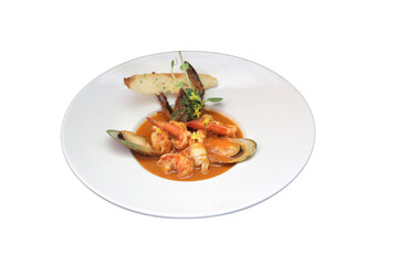 A delicious seafood dish, elegantly presented on a white plate. This vibrant dish consists of shrimps and mussels, accompanied by a slice of toasted bread