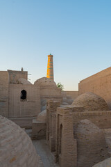Ancient Minaret and Clay Architecture in Khiva, Uzbekistan at Sunset