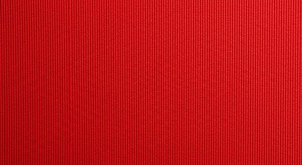 Fototapeta premium Vibrant red ribbed fabric background perfect for bold designs and festive holiday themes