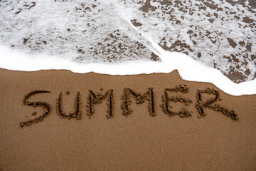 Summer writing in sand erased by ocean waves footage