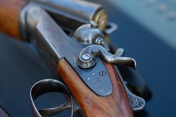 The hunting weapon lies on the hood of the car.