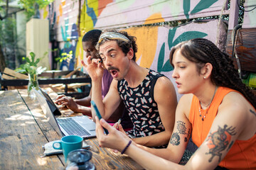 Group of young adults working and socializing outdoors