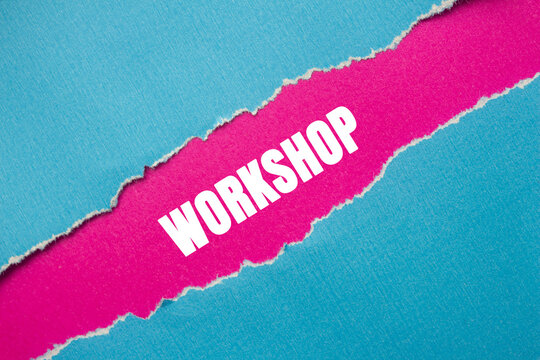 Workshop message written on ripped torn blue paper on pink background. Conceptual Workshop symbol. Copy space.