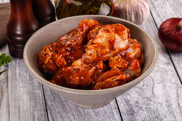 Raw marinated buffalo chicken wings