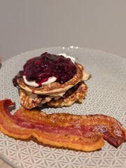 Homemade pancakes with berry compote and bacon