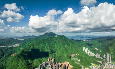 Vast green mountain range and modern city in Shenzhen.