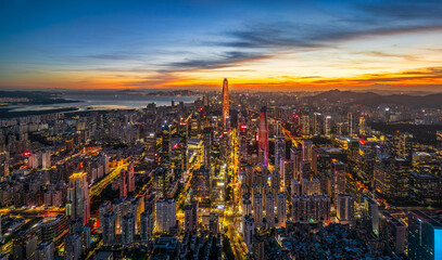 Aerial cityscape of the illuminated central business district at night with glowing city lights and...